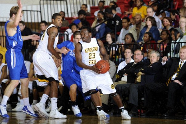 Femi Ajayi (#23) driving to the basket as a Division I basketball player at Kennesaw State University